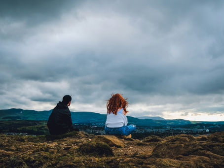 a woman and a man look at the clouds