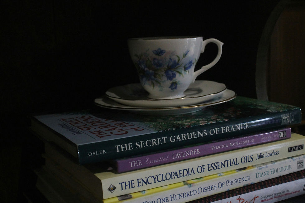A stack of books with a cup of tea