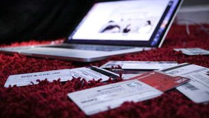Credit cards and a laptop on the floor symbolizing how high interest credit card debt grows through compound debt.