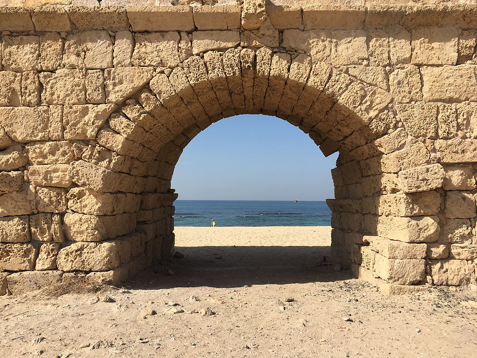 A arch of the Caesarea Aqueduct with a view of the sea
