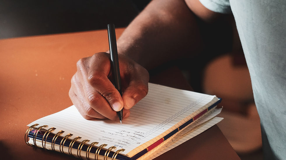 Close-up view of a notebook with handwritten notes and a pen