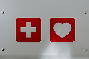 First aid and heart emergency signs marking where an AED is located