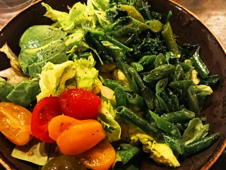 A healthy bowl of salad, tomatoes, lettuce, and beans.