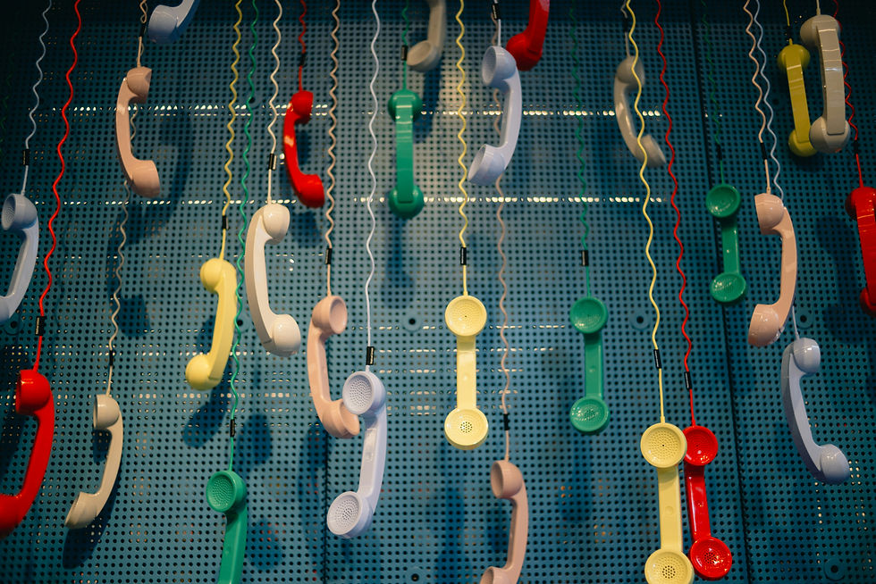 phone receivers in a variety of colors suspended in an artful way