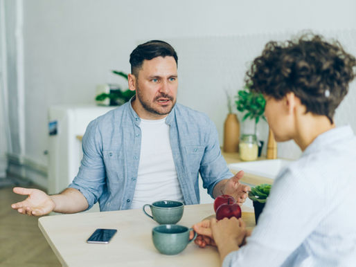 man criticizing woman at dinner table