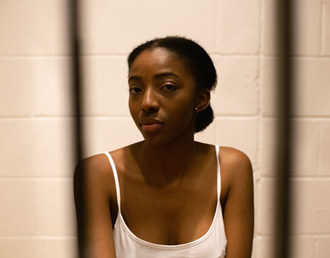 Image by Karollyne Videira Hubert of a young woman incarcerated in a detention facility.
