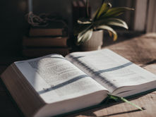 An open Bible on a table in warm natural light, symbolizing prayer, faith, and staying anchored in the word of God throughout the year.