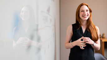 Passionate educator with a vibrant smile, reflecting the potential of smart financial planning to ensure a worry-free future in academia.
