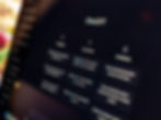 Close-up of a computer screen displaying "ChatGPT" with sections labeled Examples, Capabilities, and Limitations, set on a dark interface.