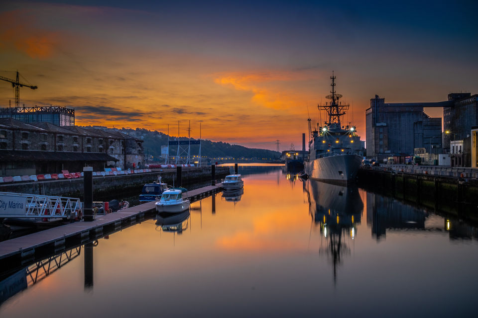 Harbor with boats and ship at sunset
