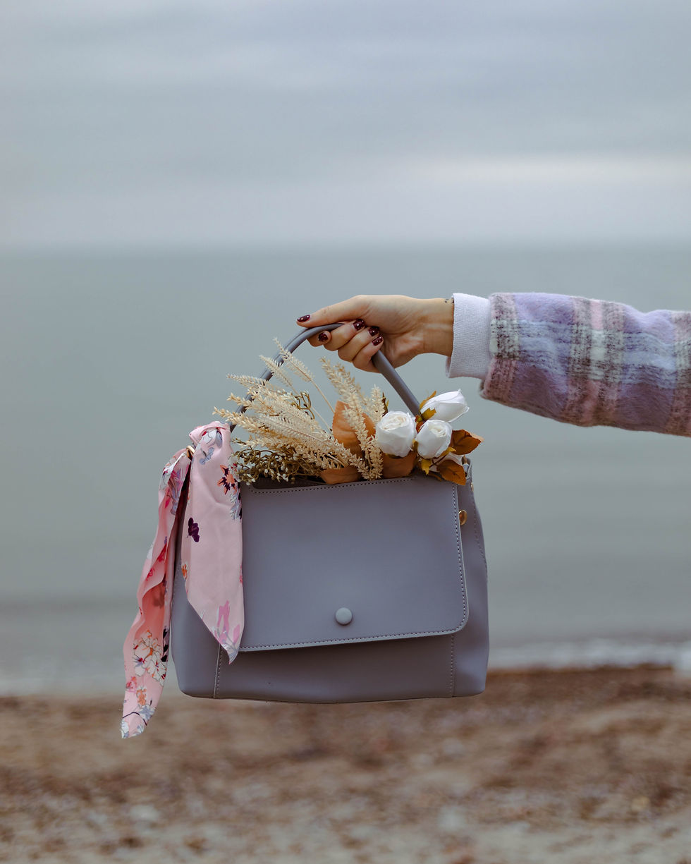 silk scarf tied on a handbag handle as an elegant accessory