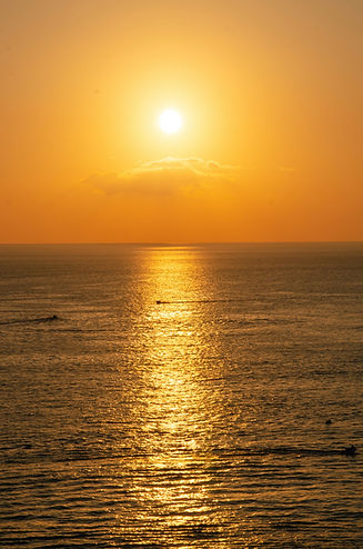 Serene orange sunset over the sea, symbolizing peace and healing, reflecting the holistic approach of R.A.Y Healing