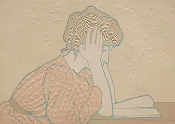image of a woman with her head in her hands symbolising the interplay between menopause and mental health