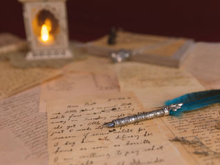 A fountain pen and some poems on old-looking paper.