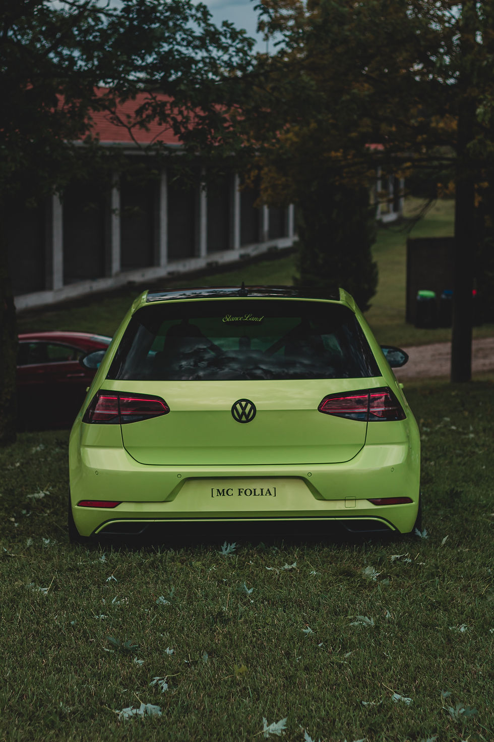 Rear view of a lime green Volkswagen Golf without plates