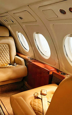 Cream leather seats in a private jet cabin