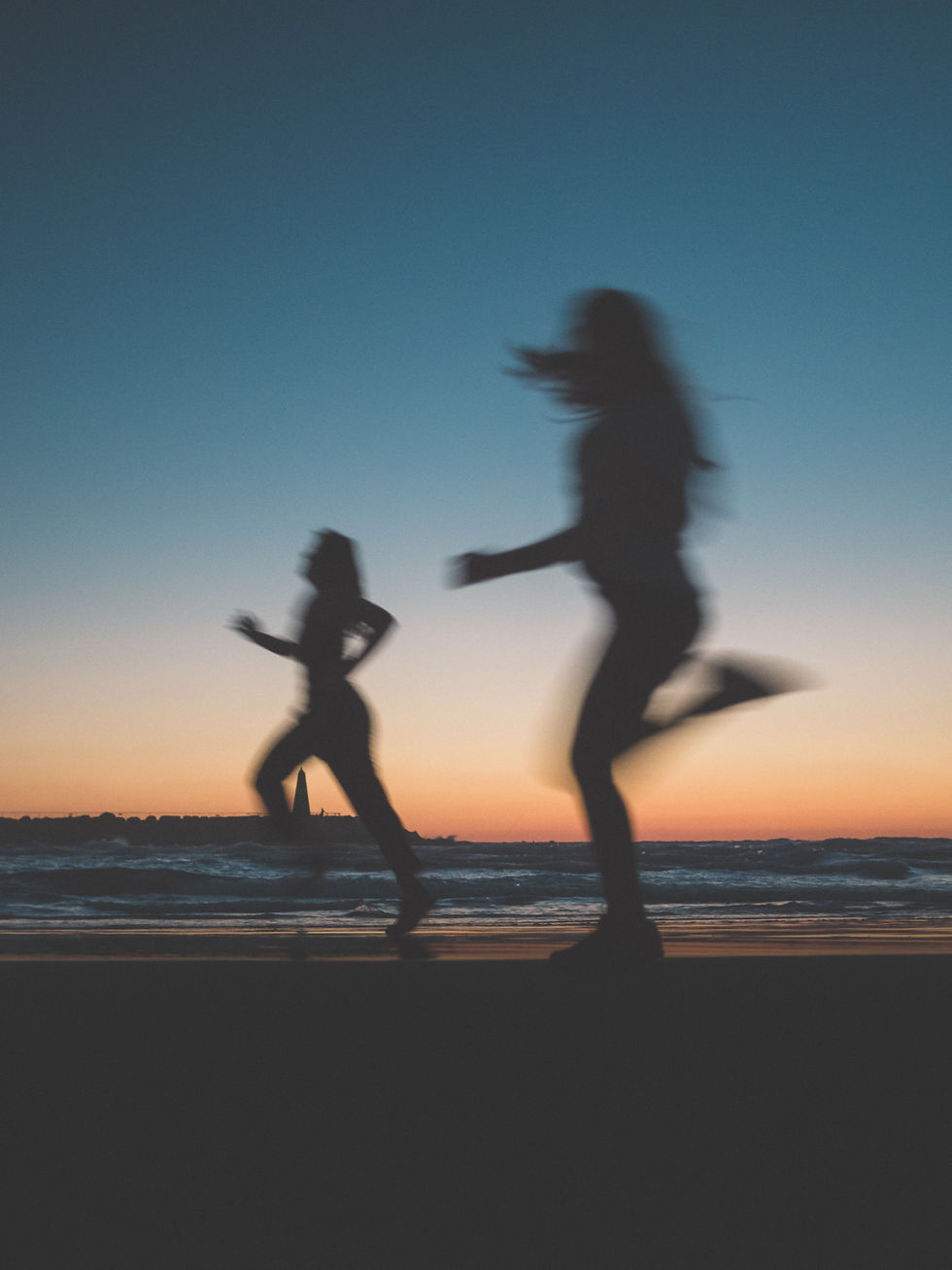 People jogging along the Tel Aviv beachfront, showcasing an active community lifestyle.