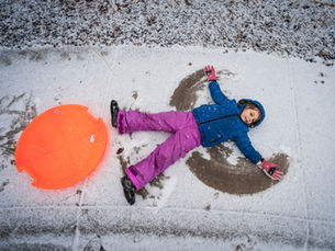 Child making a snow angel