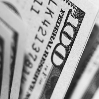 black and white image of close-ups of hundred dollar bills