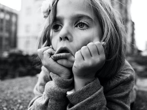 Young girl pulling her face down with her hands seeming distressed