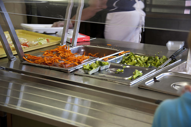 School cafeteria serving line with prepared meals and food service operations