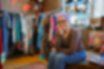 Woman with purple hair in a vintage clothing store