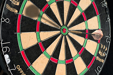 A dart hitting a bullseye, symbolizing the focused goal of a successful church capital campaign.