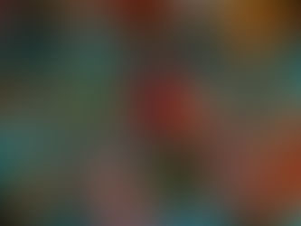 Colorful, intricately painted masks hanging on a bright turquoise wall. Patterns include flowers, spots, and animal faces, evoking vibrant culture.