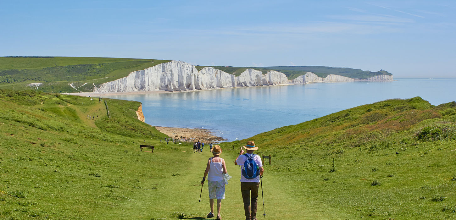 Retirees Hiking Down a Mountain