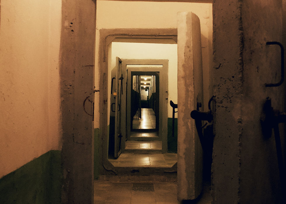 Interior view of Bunk'Art 1 museum in Albania with dim lighting, underground tunnels, and exhibits depicting the country's communist past