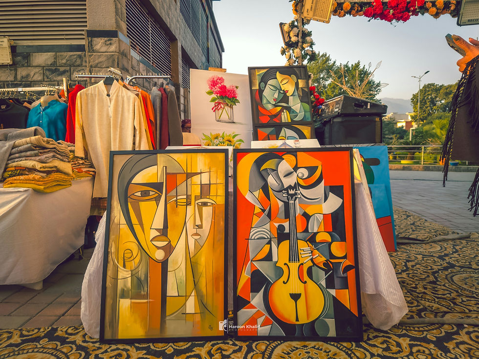 Photograph of a street vendor's stand with a few framed Picasso prints for sale.