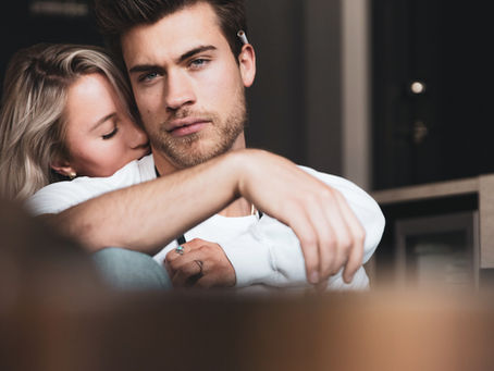 Woman hugging a man from behind, showing affection, emotional support, and connection in a relationship.