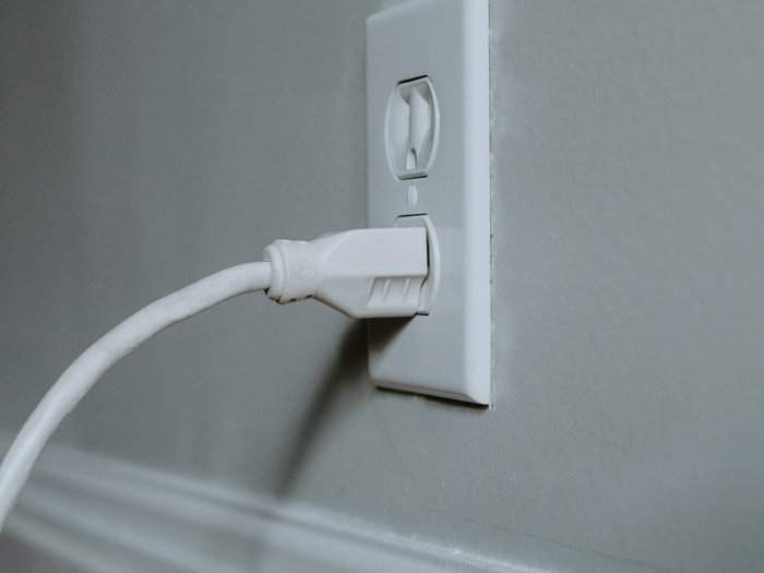 White cable plugged into a wall socket