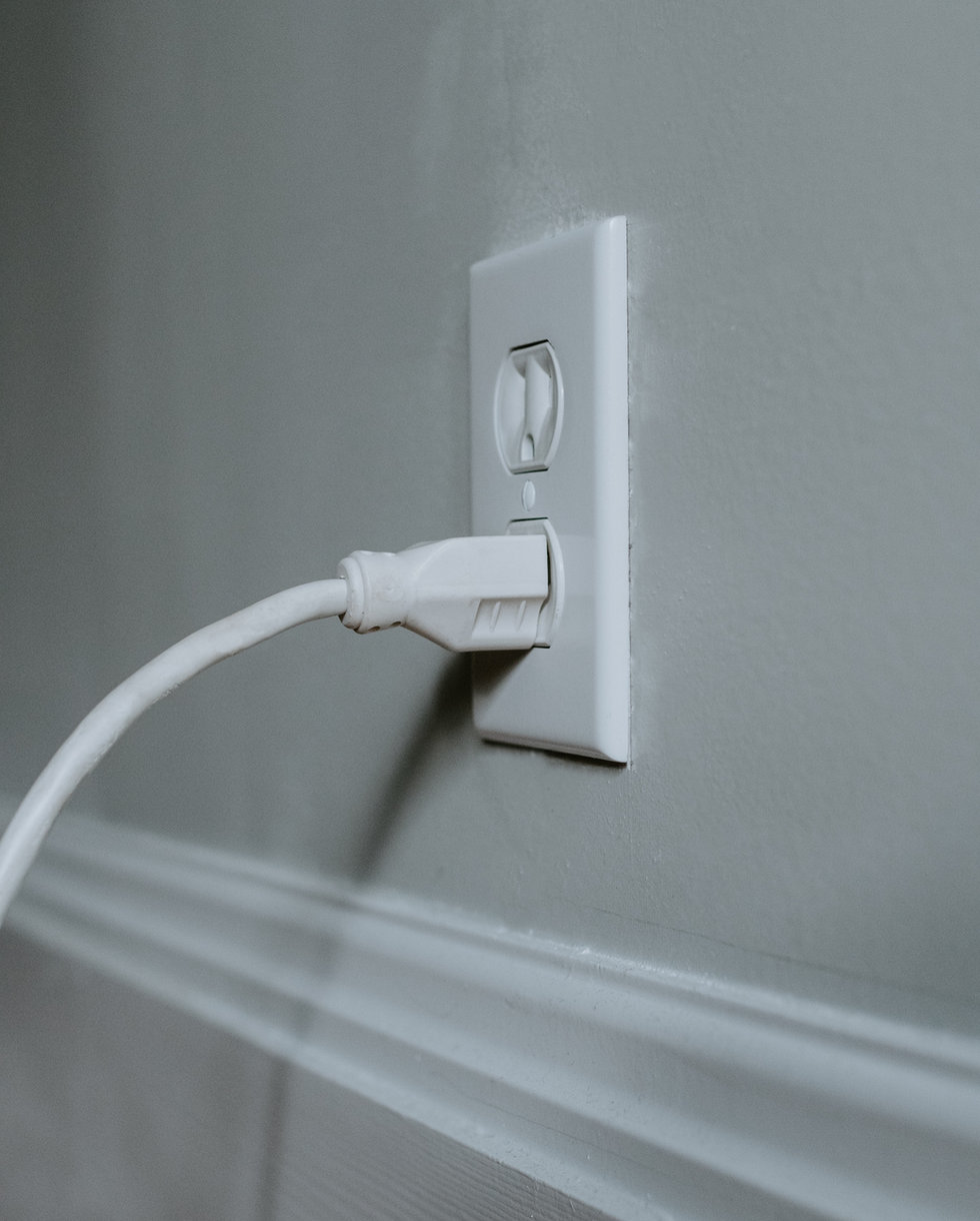 White cable plugged into a wall socket