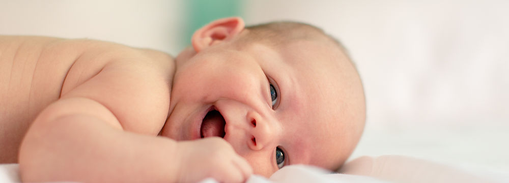 baby laying down on bed