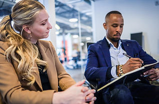 A man and a woman business partners analysing work