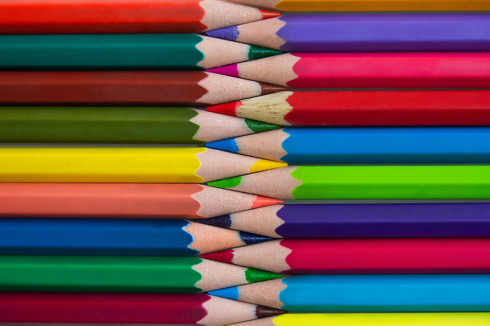 Colorful colored pencils stacked closely in alternating horizontal layers, showing a vibrant mix of tips in various hues.