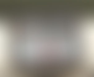 iPad displaying Pinterest login screen with collage of photos. A black keyboard is in the foreground on a wooden surface.