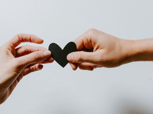 image of two people sharing a heart shape