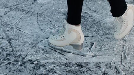 Ice skates on an icy pond