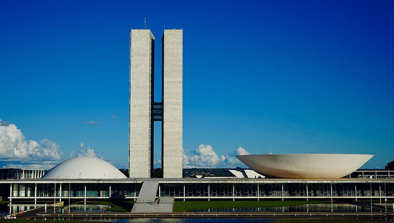 Three white government buildings designed with modernist architecture in Brasilia