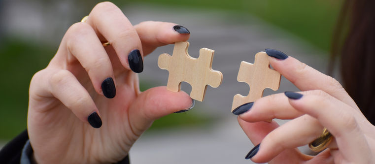 Hands carefully placing a puzzle piece into position on a partially assembled puzzle with warm light, representing the stroke recovery discovery that most pieces that feel missing have not disappeared but simply moved — waiting to be found in a new form in a corner of life not yet explored.