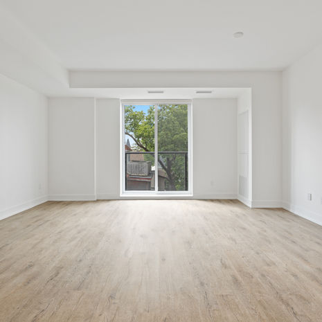 an empty apartment with a balcony and a large window