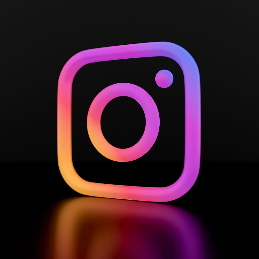 The image shows the Instagram logo with a glowing gradient of pink, purple, orange, and yellow on a black background.