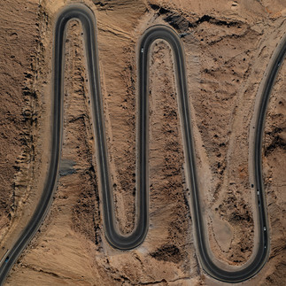 The winding Ma'ale HaAtzmaut road descending into the heart of the Ramon Crater from Mitzpe Ramon.