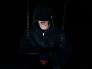 Laptop open in a dark environment representing AI-powered dark web hacking tools WormGPT and FraudGPT vs ChatGPT