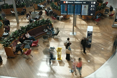 looking down over a busy airport departure lounge