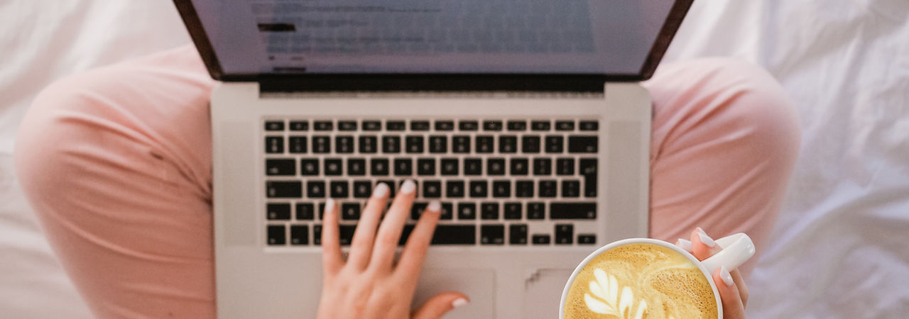 girl with laptop and coffee mug doing work