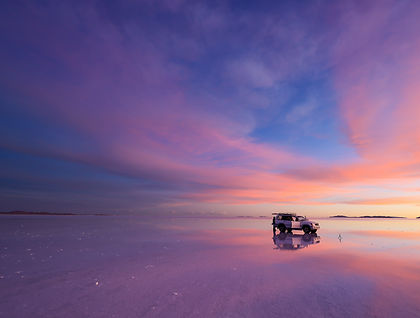 This long-range South American itinerary links Argentina, Bolivia, and Chile through a journey that focuses on high-altitude landscapes, desert plateaus, and culturally rich cities. It begins in Argentina, typically in Buenos Aires, where time is spent exploring neighbourhoods shaped by European influence, wide avenues, and a strong café culture. From there, the route moves north into the Andean regions, where the scenery shifts into arid valleys, colourful rock formations, and traditional towns that reflect a blend of Indigenous and colonial heritage.
Crossing into Bolivia, the journey reaches some of the most visually striking environments in the region, including the vast salt flats of Uyuni and surrounding high-altitude deserts. These landscapes are defined by wide horizons, extreme clarity of light, and a sense of isolation that contrasts sharply with the earlier urban settings. Travel continues through small settlements where daily life is closely tied to altitude and environment.
In Chile, the itinerary typically concludes in the Atacama Desert and possibly Santiago, offering further contrasts between desert plateaus and modern urban life. The Atacama region in particular is known for its dry valleys, volcanic backdrops, and expansive night skies. Overall, the journey is structured as a gradual transition through some of South America’s most distinctive environments, linking cultural centres with remote natural landscapes in a single overland route.
