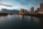 Austin, Texas skyline at dusk with downtown buildings reflected in Lady Bird Lake, representing the city's vibrant wellness and contrast therapy scene